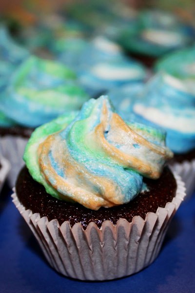 Close up of one fudgy mini cupcakes with earth toned frosting.