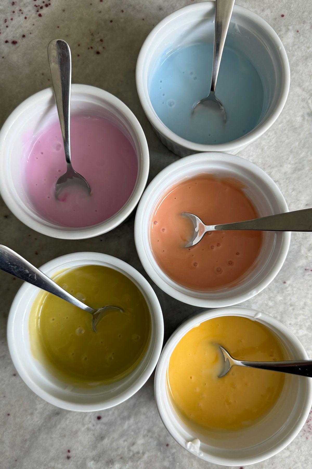 Icing colors in separate bowls.