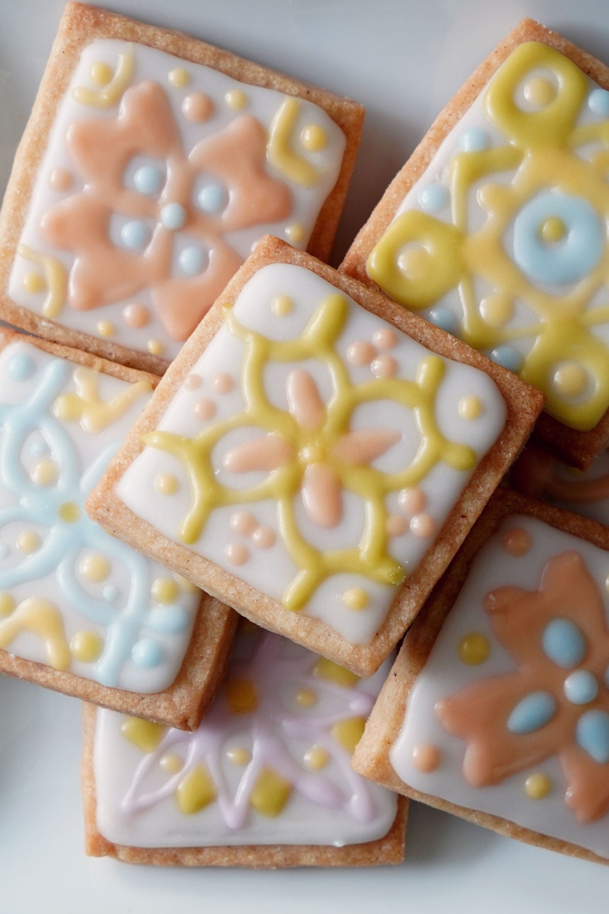 Rangoli Cookies close up overhead on a white plate.