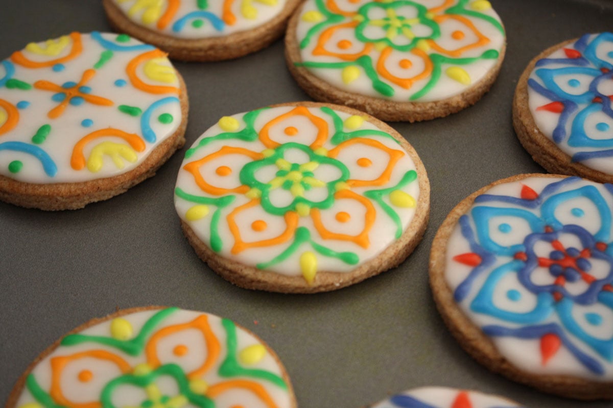 Rangoli designs on round shaped cookies.