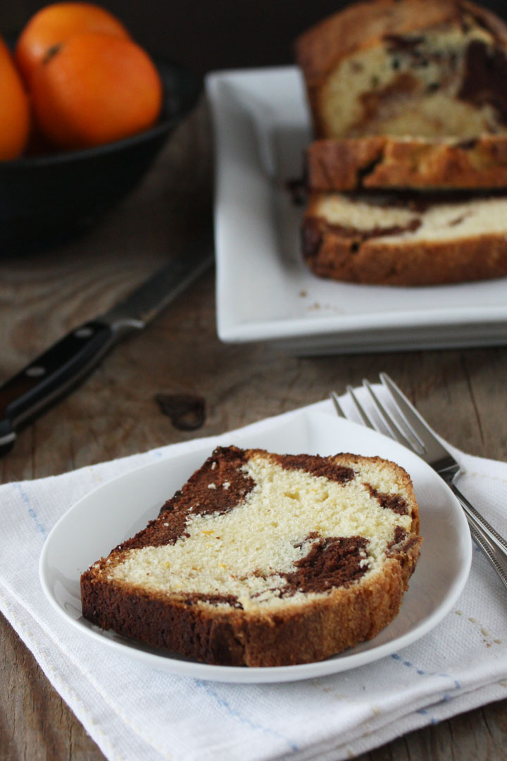 Orange marble pound cake slice with pound cake loaf