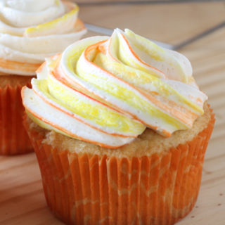 Mango Cupcakes with swirl colored frosting in a plate