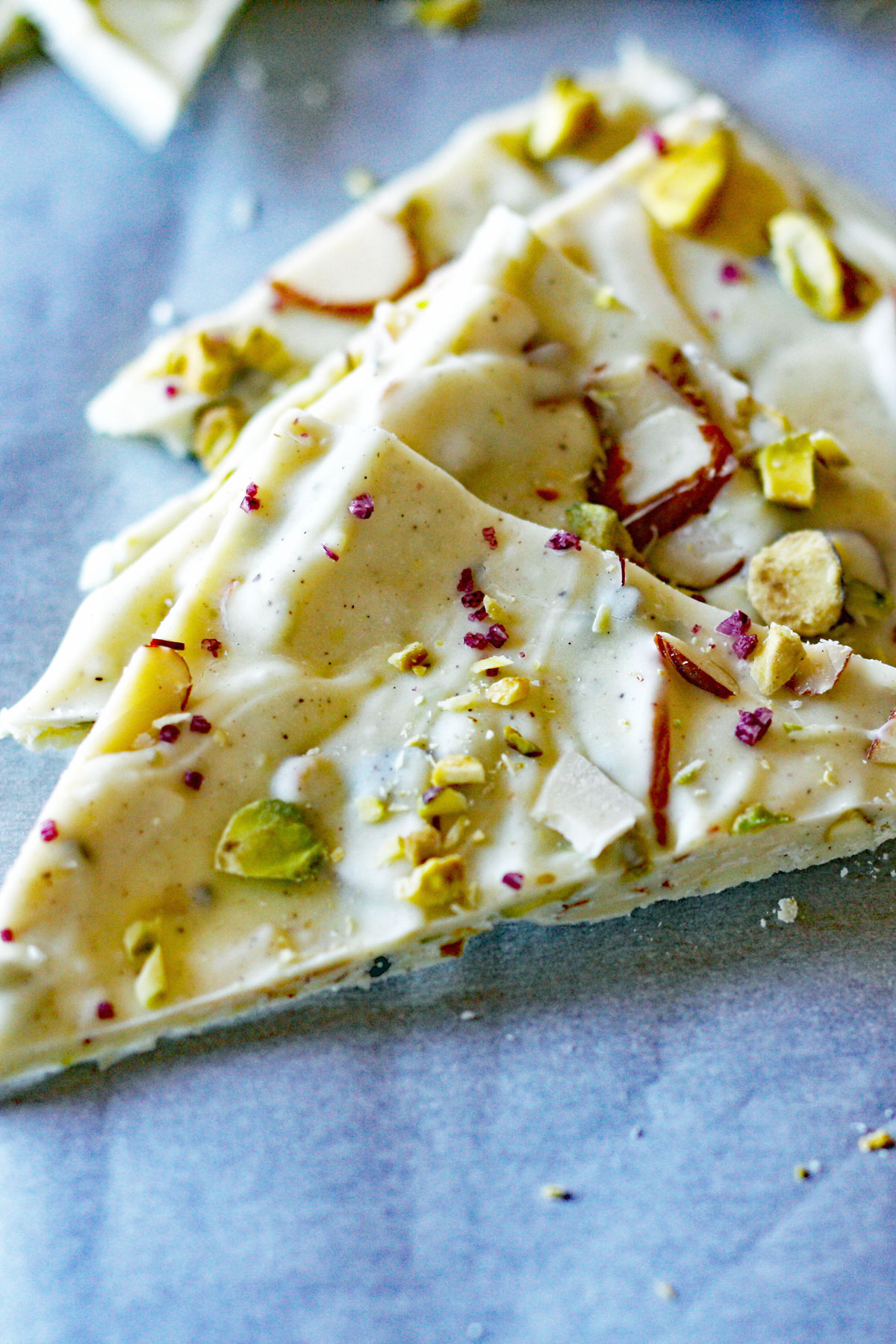 Close up of Indian inspired white chocolate bark made with pistachios, cardamom, and saffron.