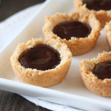 Mini coconut ganache pies in white tray.