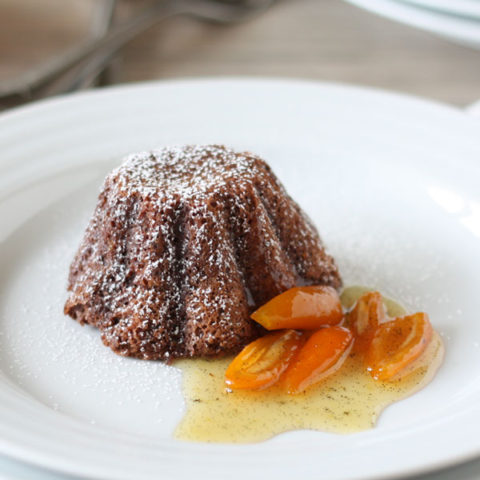 Chocolate lava cake plated with kumquat sauce