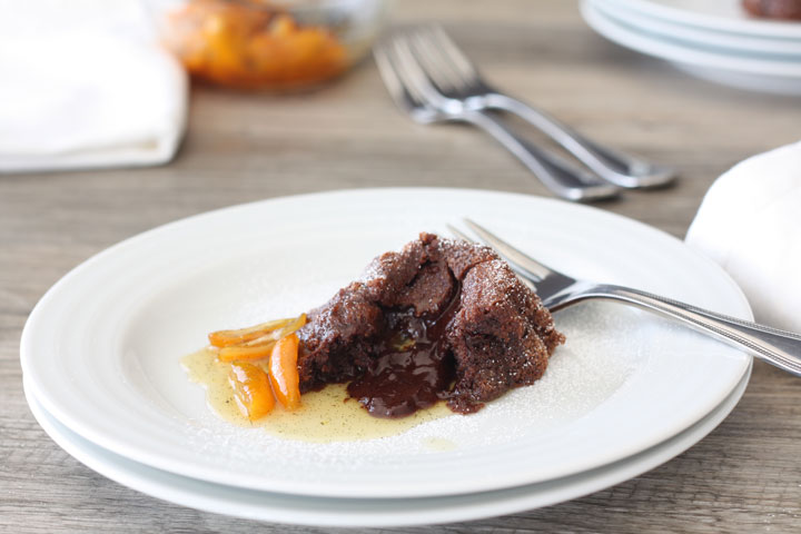 Broken chocolate lava cake plated with kumquat sauce