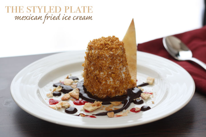 Fried ice cream in a plate of chocolate and berry sauce with cinnamon tortilla chips