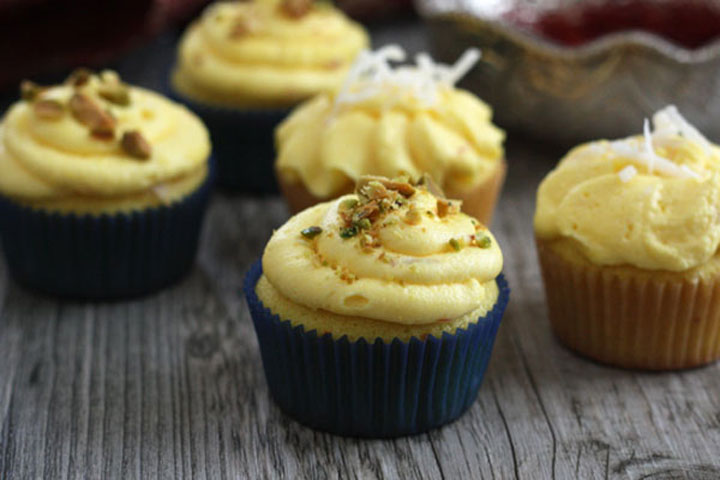 Saffron cupcakes topped with golden saffron buttercream with coconut or pistachio garnishes.