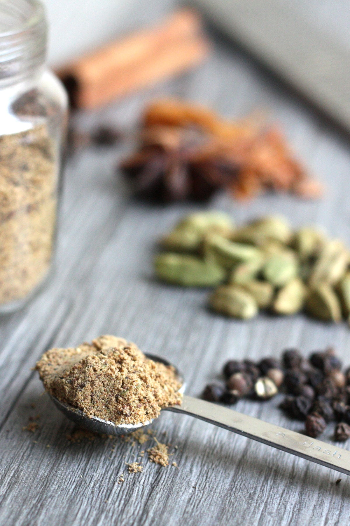 Close up of chai spice mix in a spoon.