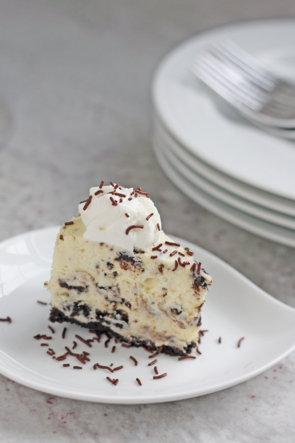 A slice of Instant Pot oreo cheesecake on a white plate.