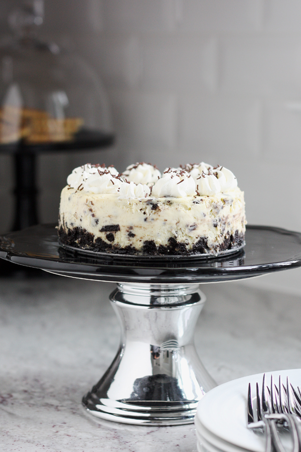 Instant Pot oreo cheesecake on a pedestal cake stand.