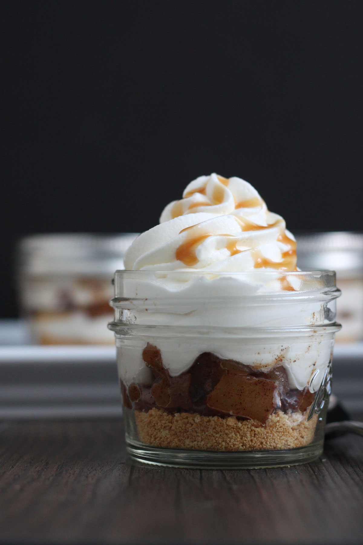 Closeup view of apple pie cheesecake jar showing layers. 