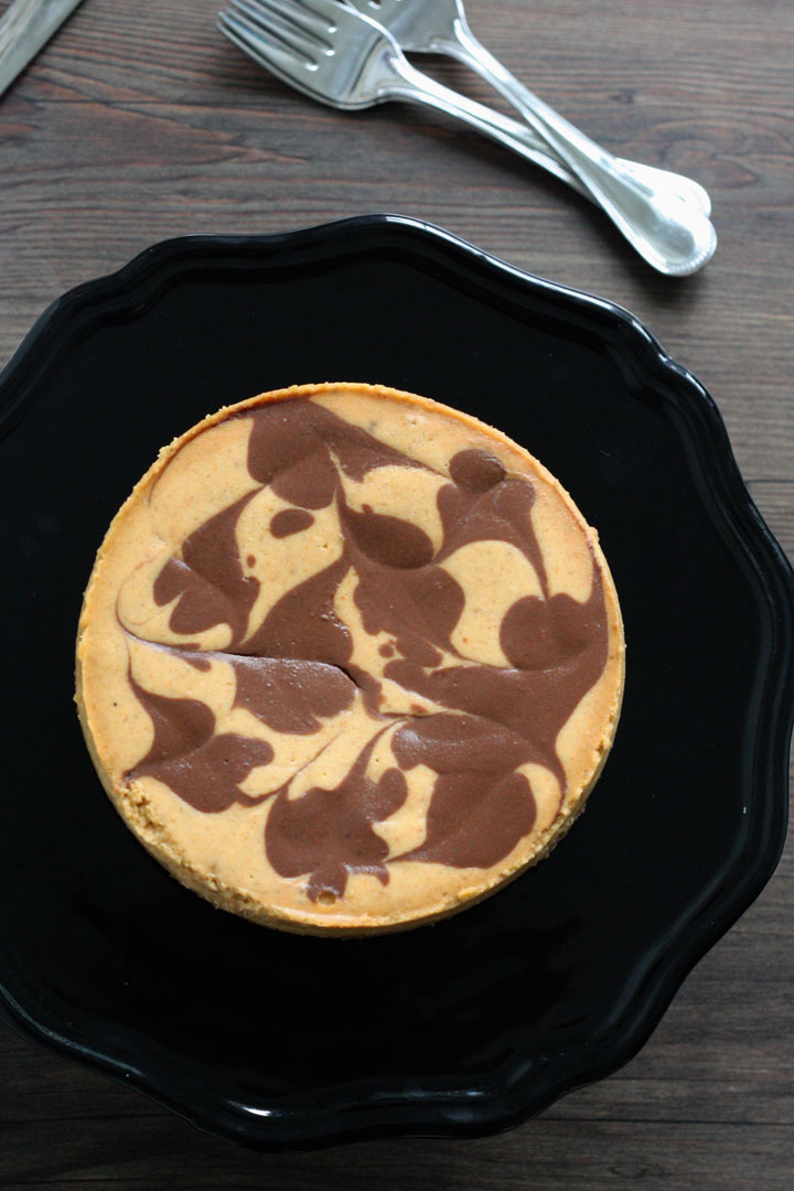 Top view of entire pupmkin cheesecake showing all the chocolate swirls.