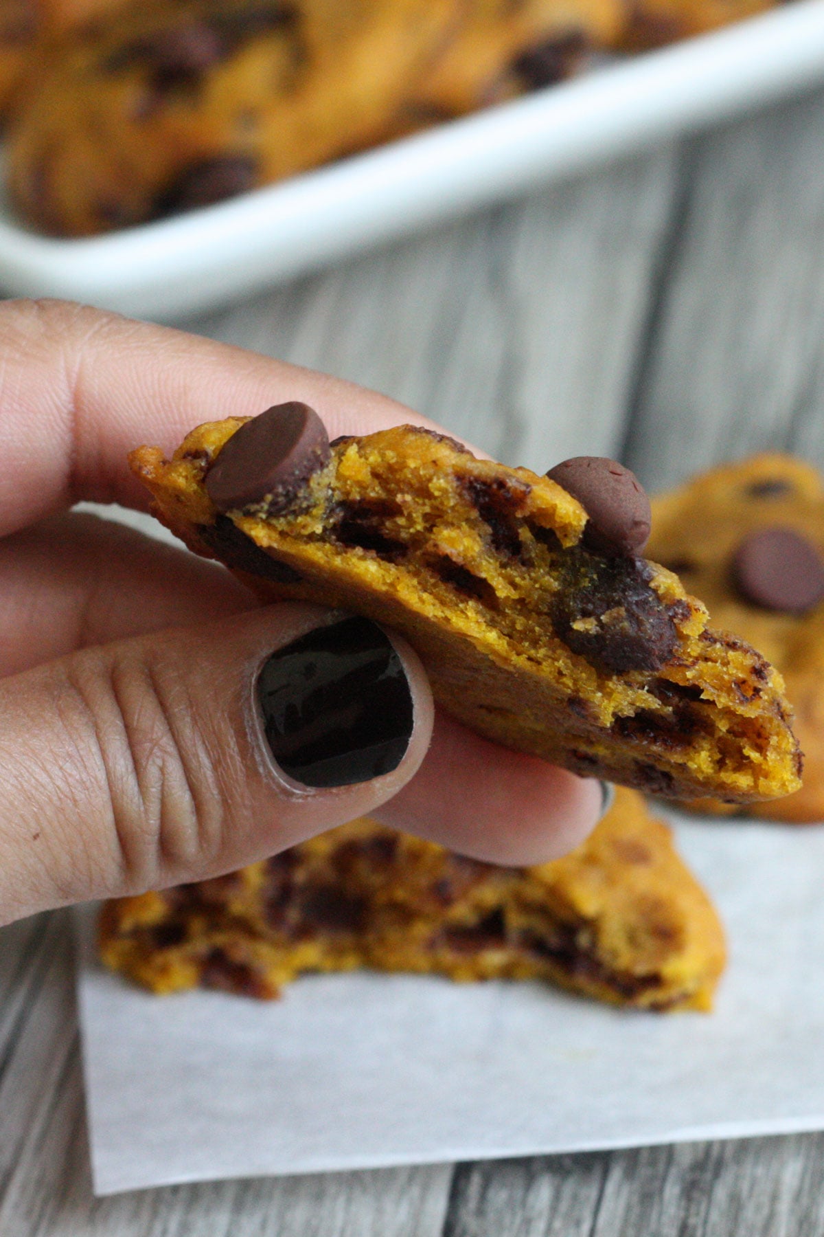 Pumpkin Cookie broken in half showing the inside texture.