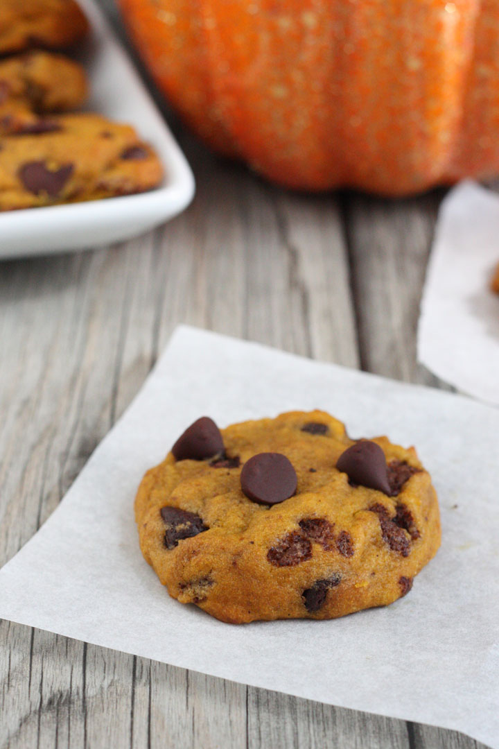 Pumpkin chocolate chip cookie on parchment paper .