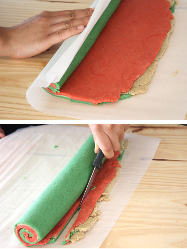 Red, green and plain cookie dough being rolled and trimmed to make Christmas Nankhatai pinwheel cookies