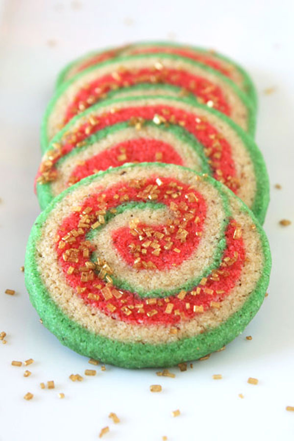 Red, white and green pinwheel nankhatai cookies sprinkled with gold sugar.