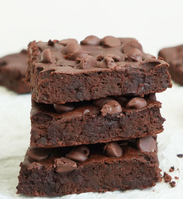 Three black bean brownies stacked on top of each other.