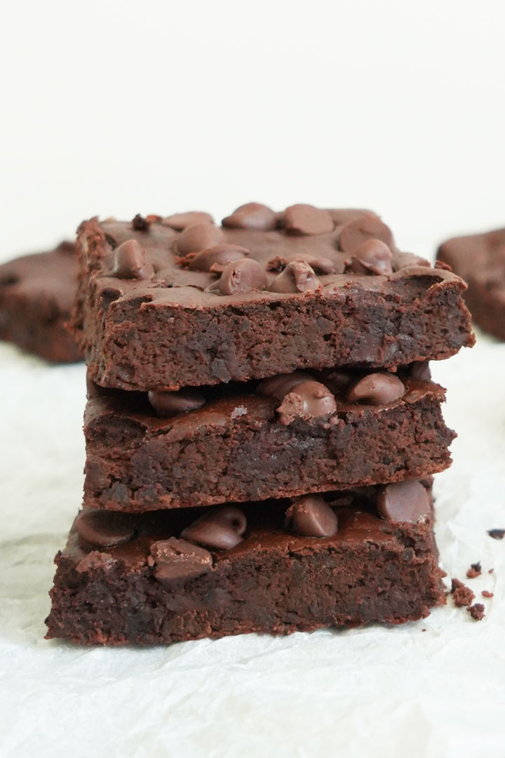 Three black bean brownies stacked on top of each other. 