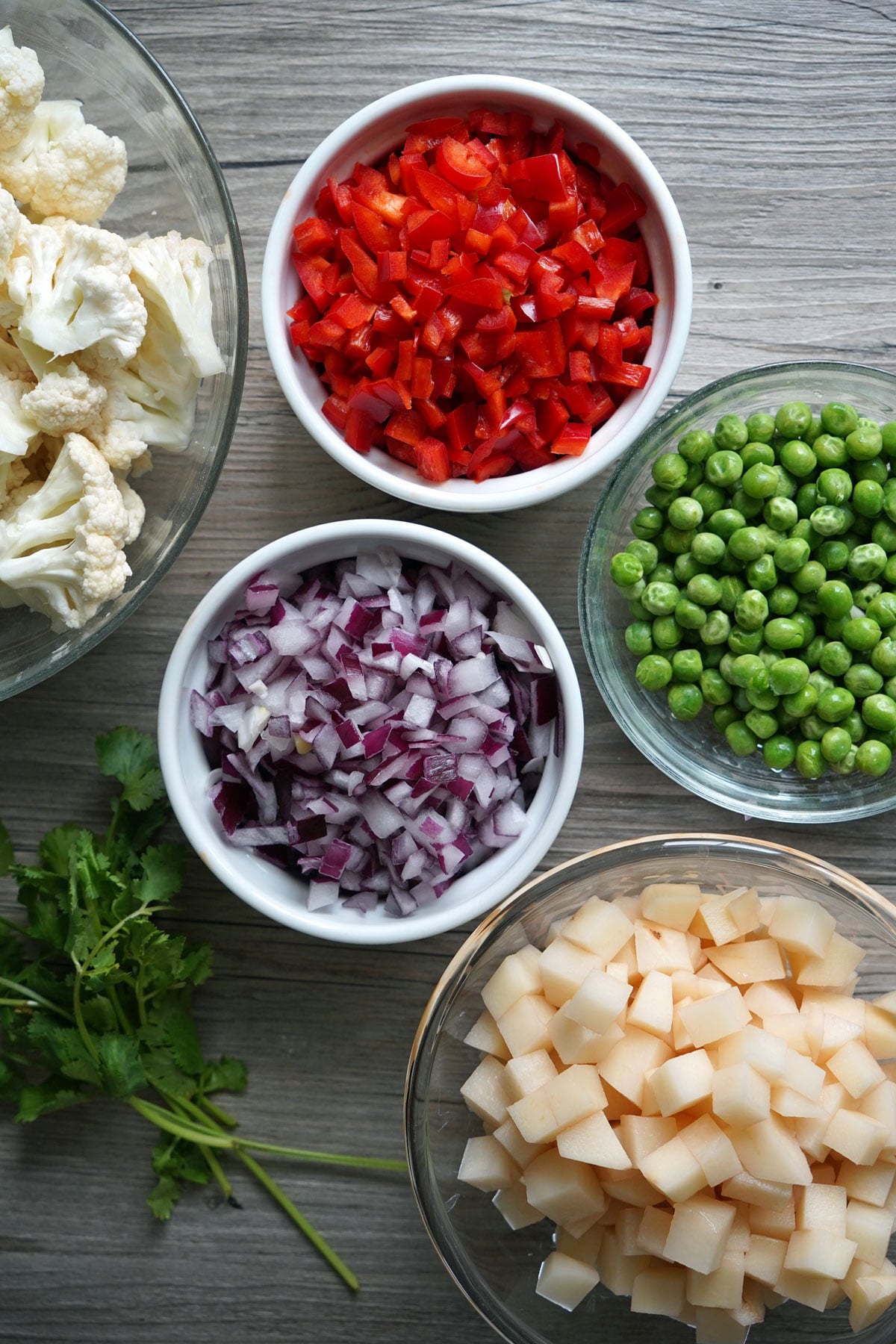 Vegetables prepared for making pav bhaji: cauliflower, bell pepper, onion, peas and potato.