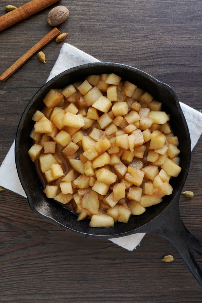 Overhead shot of cooked apples in a cast iron skillet.