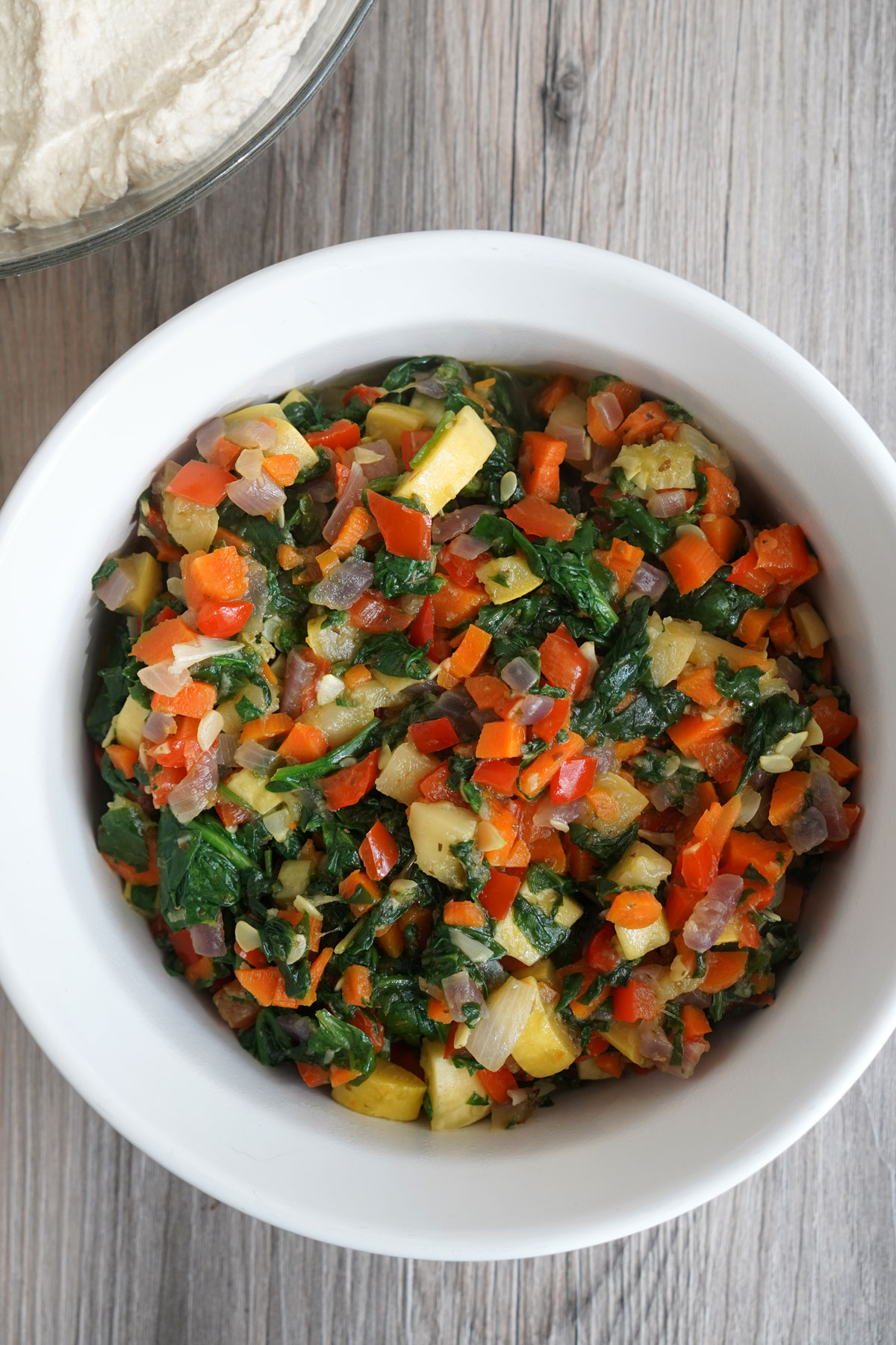 Cooked vegetable mixture in white bowl.