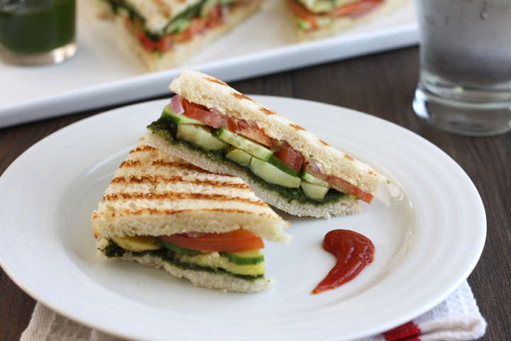 Bombay sandwich halves on white plate with ketchup.