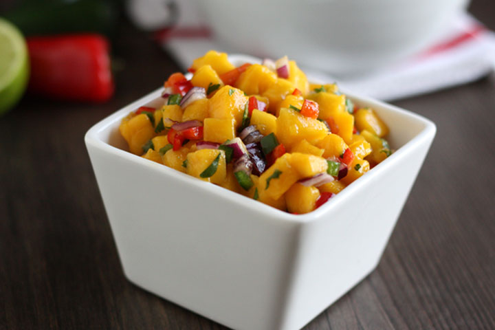 Mango salsa in a white square bowl.