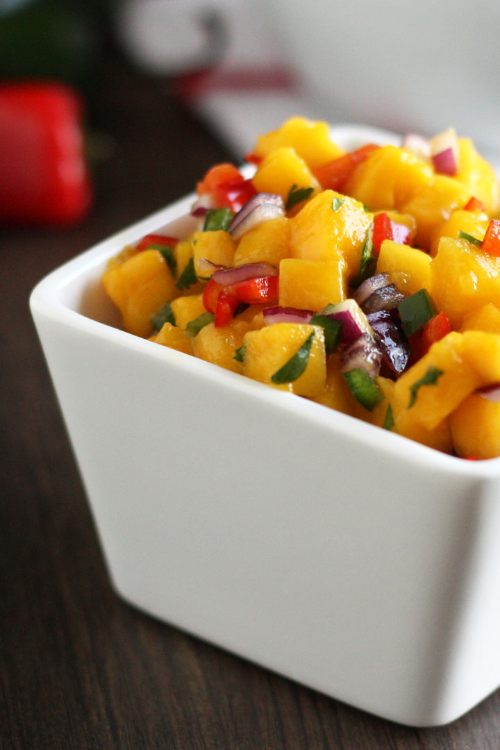 Mango salsa in a square white bowl.