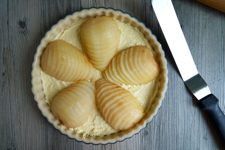 Uncooked pear and frangipane overhead shot.