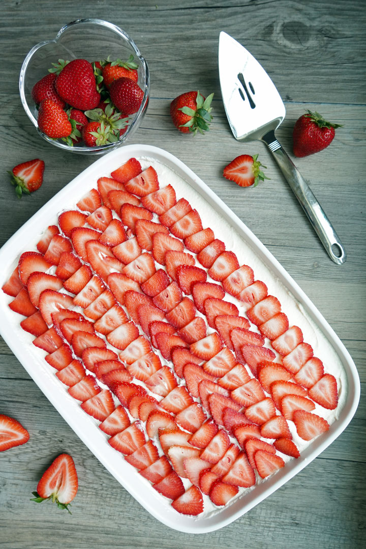 Top view of strawberry tiramisu showing top layer of strawberries.