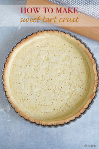 Top view of baked sweet tart crust in a tart pan.