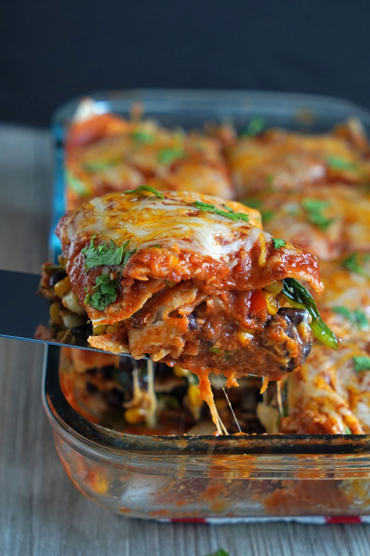 Close up of piece of casserole being removed from tray with spatula.