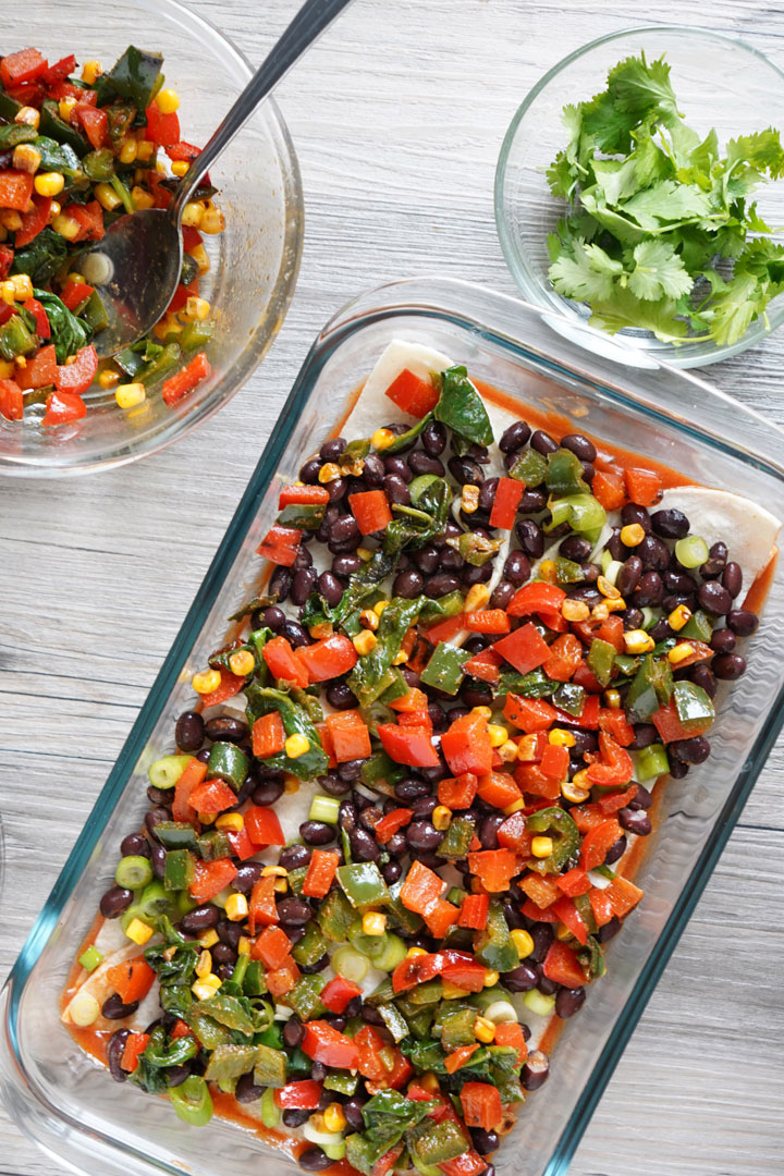 Top view of casserole being assembled with vegetable layer on top.