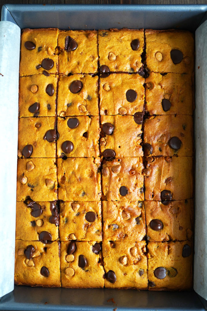 Butterscotch pumpkin cake bars in a metal pan and cut into squares.