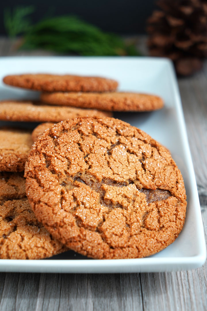 Close up view of gingersnap cookies on white tray.