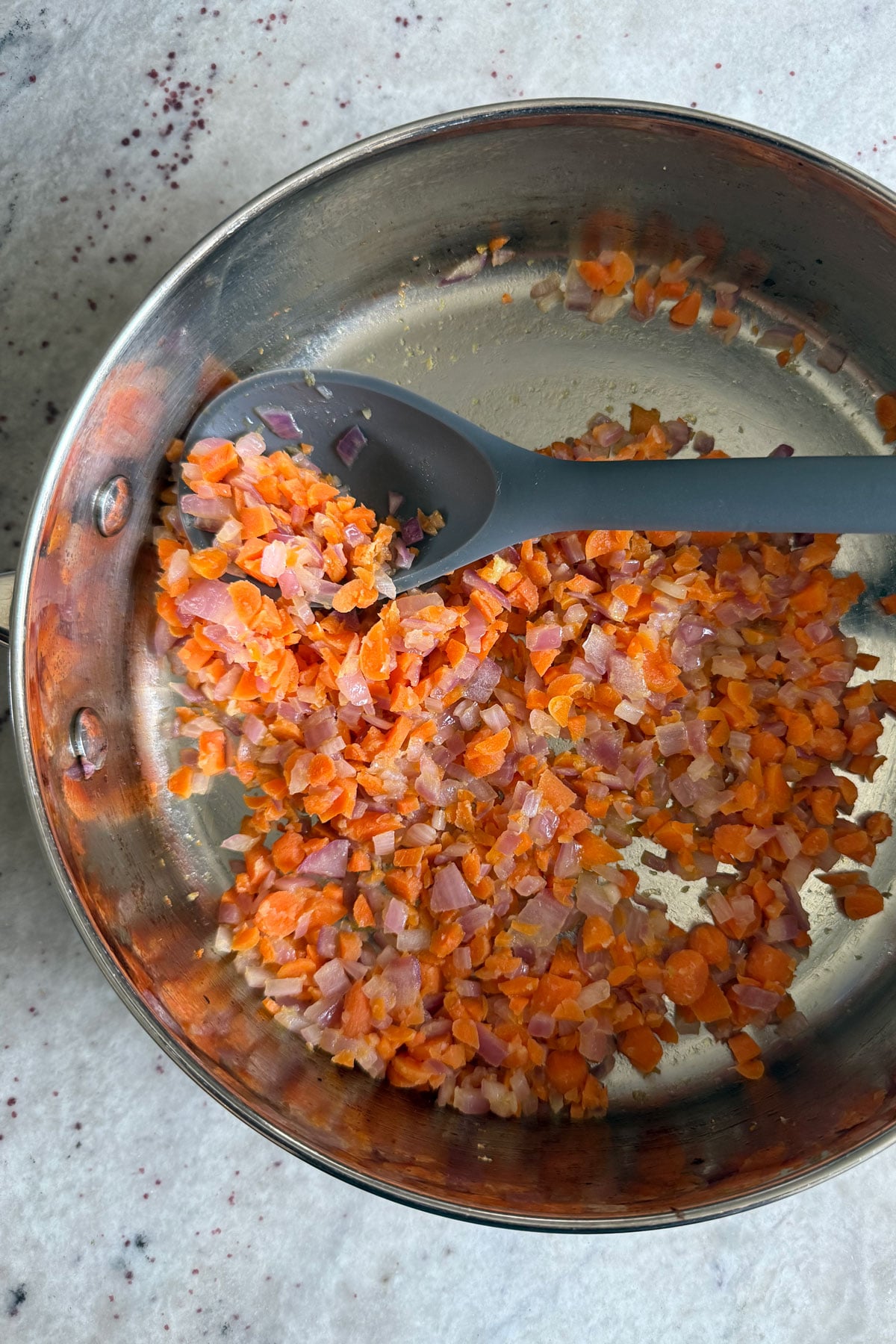 Sauteed onions, carrots, galic in pan.