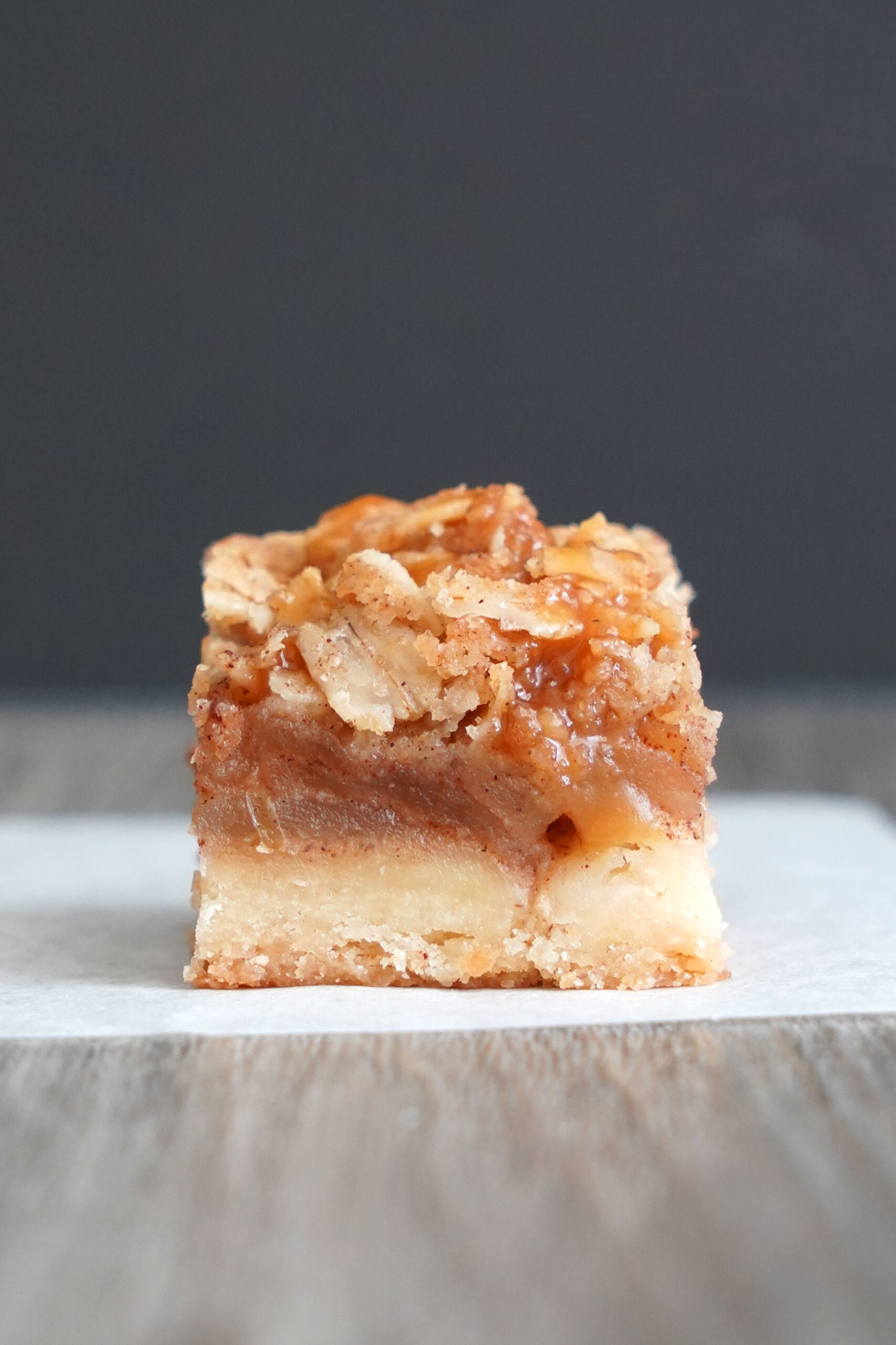 Close-up of a single bite-size salted caramel apple pie bar.