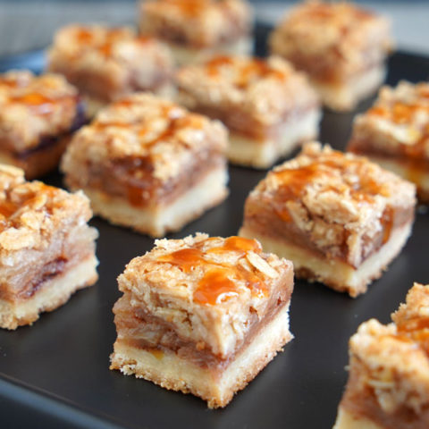 Apple Pie Bars on a black tray.