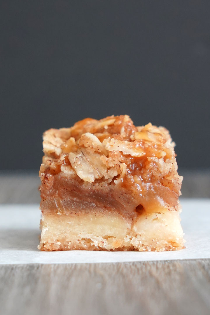 Close up view of one mini salted caramel apple pie bar.