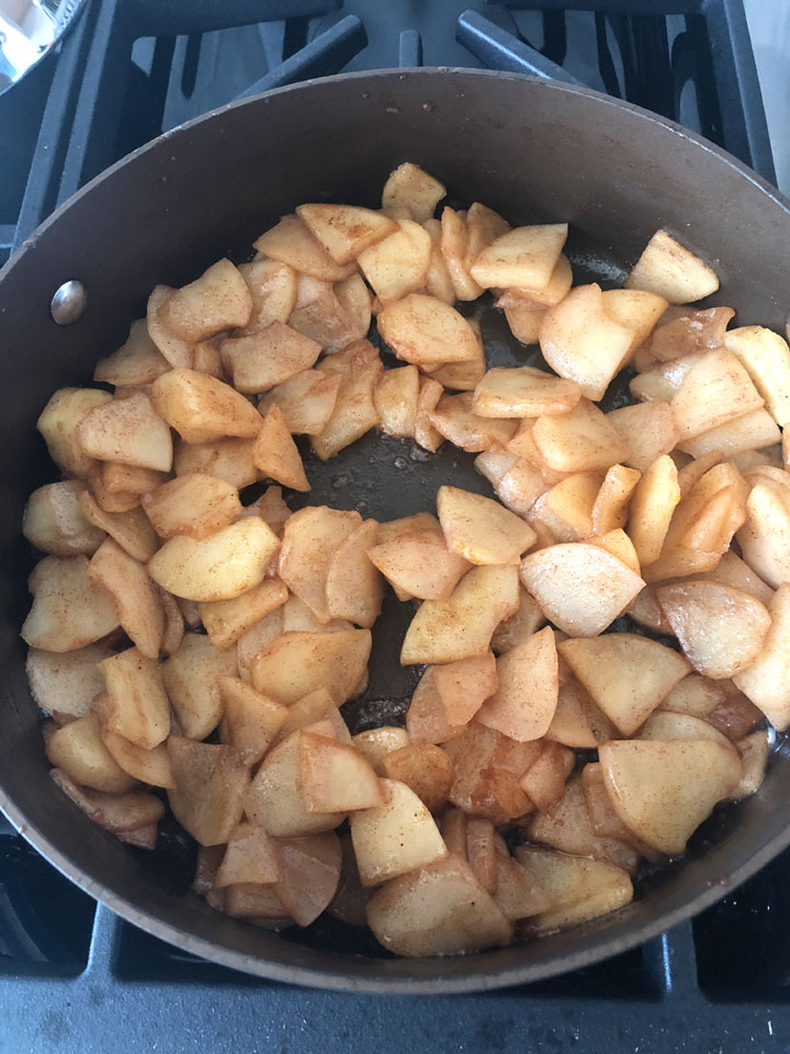 Apples cooked down in a pan.