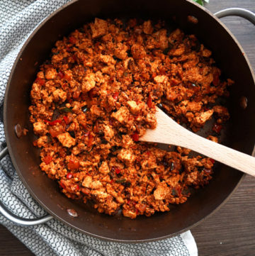 Cooked sofritas in a pan with wooden spoon.