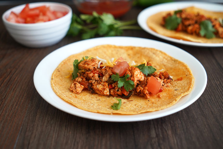 Sofritas on a corn tortilla in a white plate.