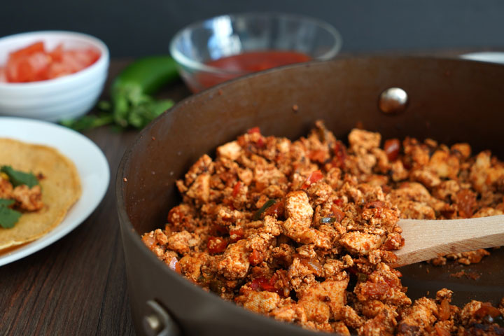 Cooked sofritas in a pan with wooden spoon.