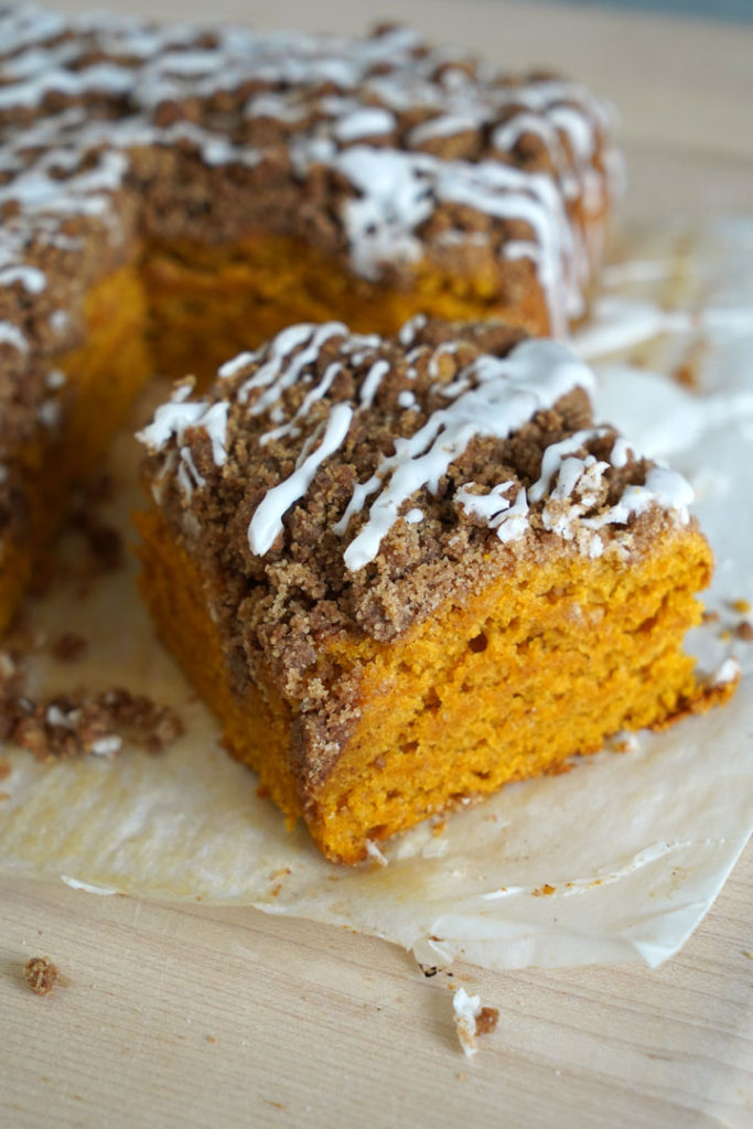 Cut piece of pumpkin coffee cake with cinnamon streusel.