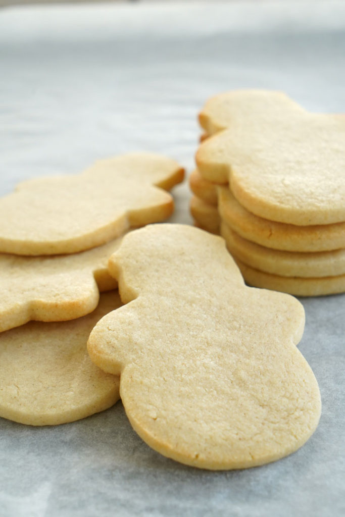 Unfrosted snowman shaped sugar cookies.