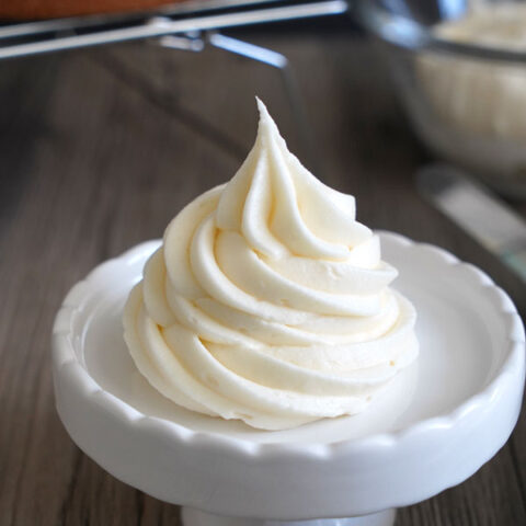 Cream cheese frosting shown piped on a small stand.