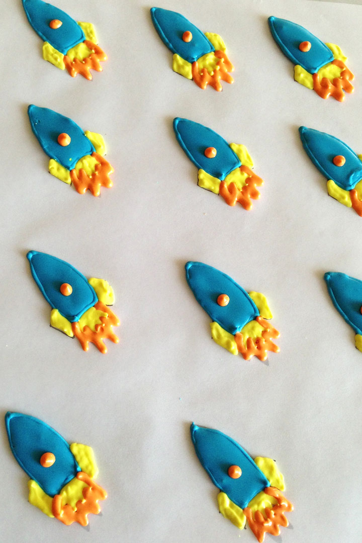 Blue rockets made with royal icing to be used for decorations on cakes and cupcakes.