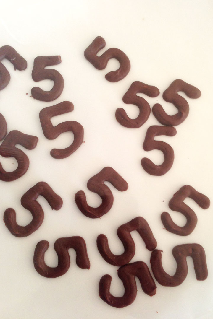 Number 5s piped out with dark chocolate.