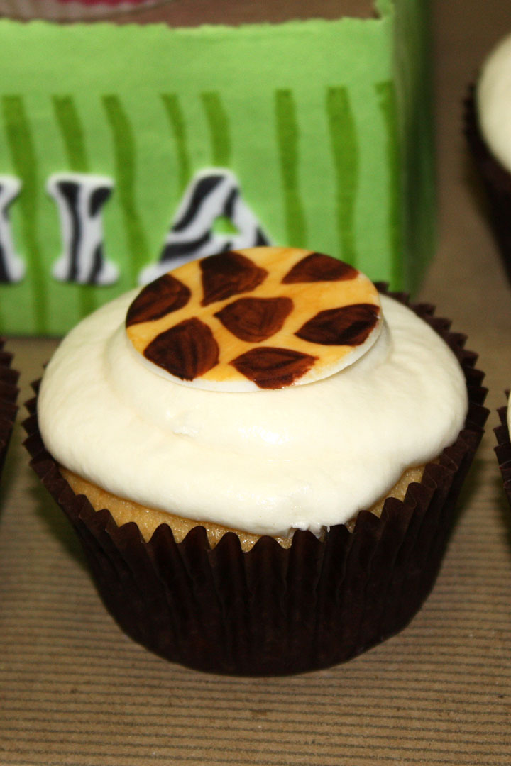 Cupcake topped with giraffe design cupcake topper.